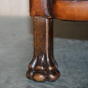 Victorian Chesterfield leather canapé with oak lion claw feet.