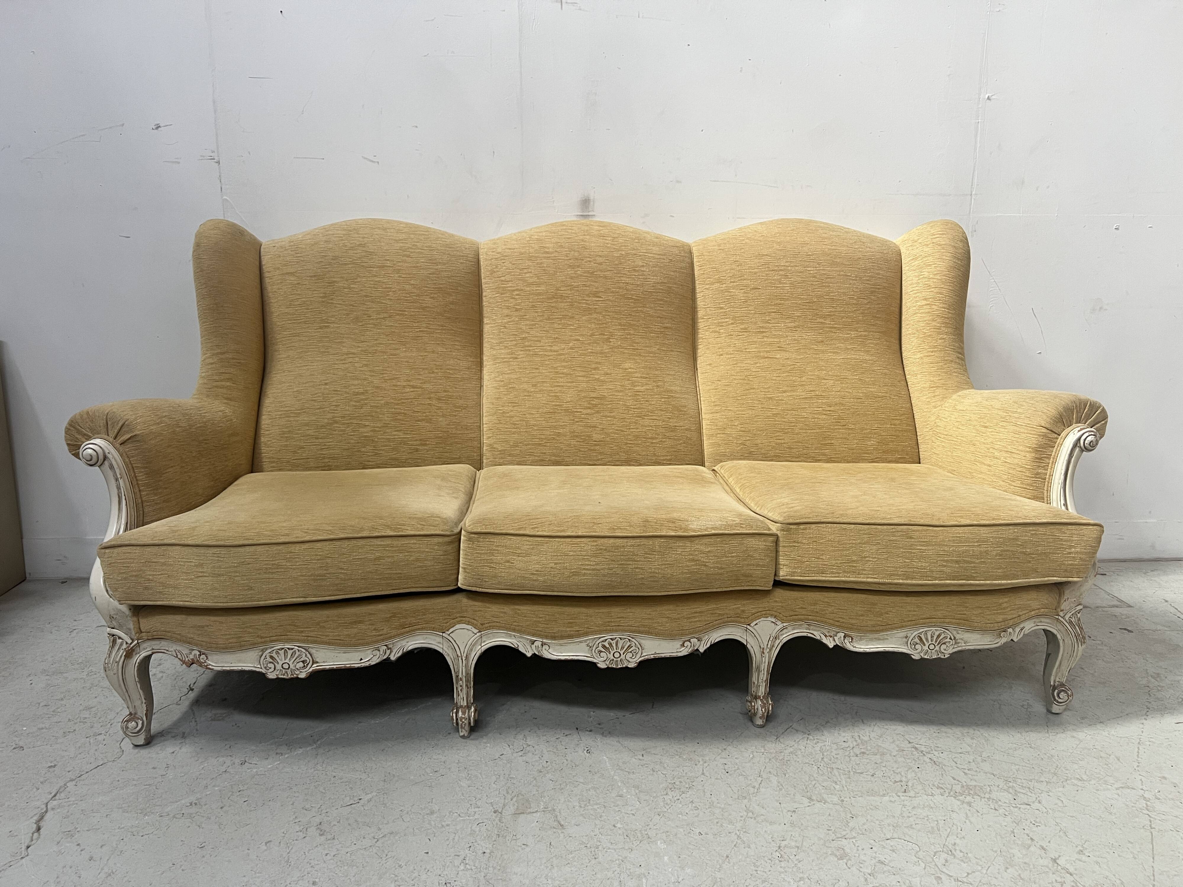 Louis XV style three-seater wingback sofa in patinated beech, 20th century