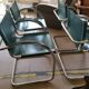 4 vintage Italian armchairs in green leather and chrome metal.