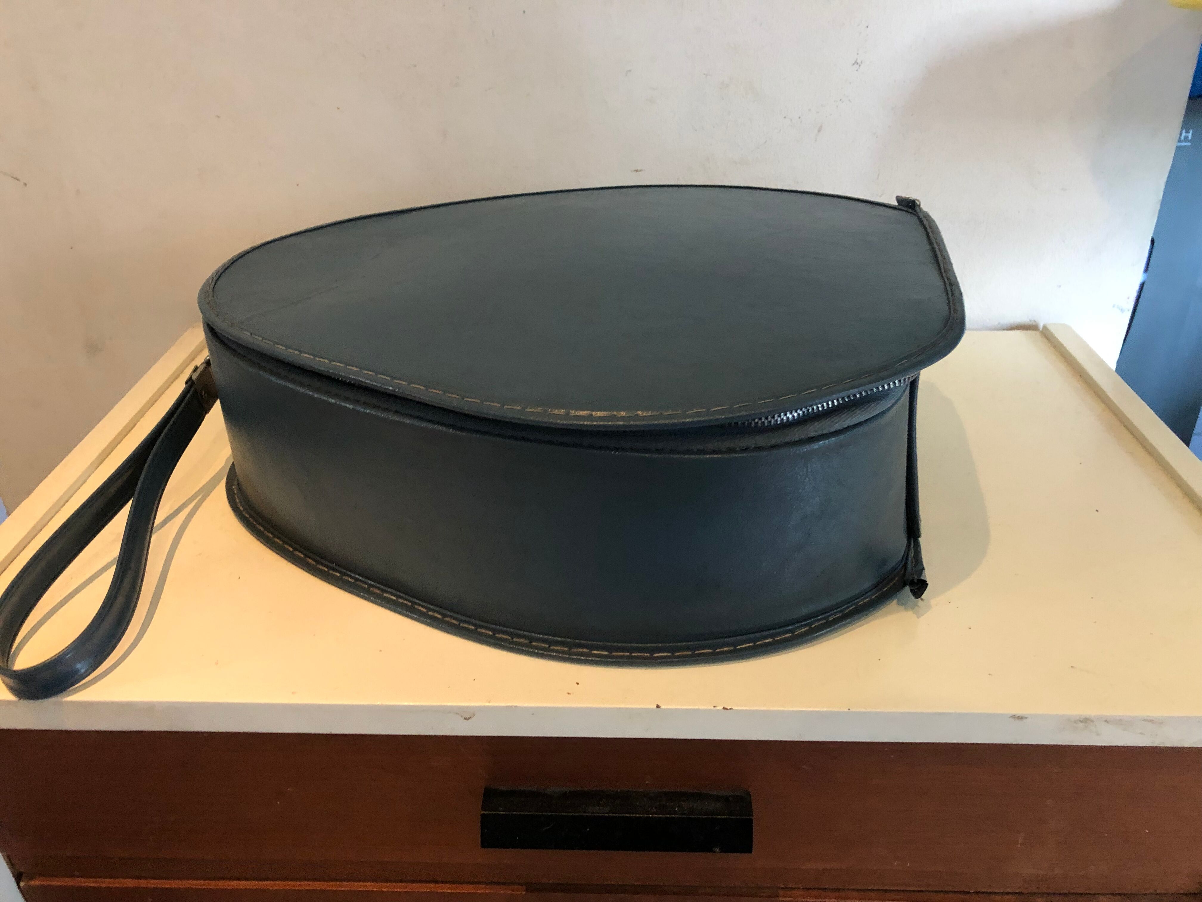 Suitcase has an air hostess hat