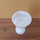 Footed glass in the shape of a chalice in white opaline with a floral decoration.
