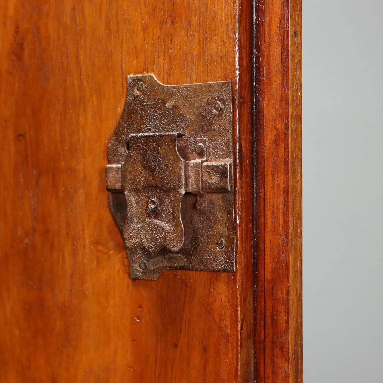 Vintage walnut wardrobe with exposed hardware.