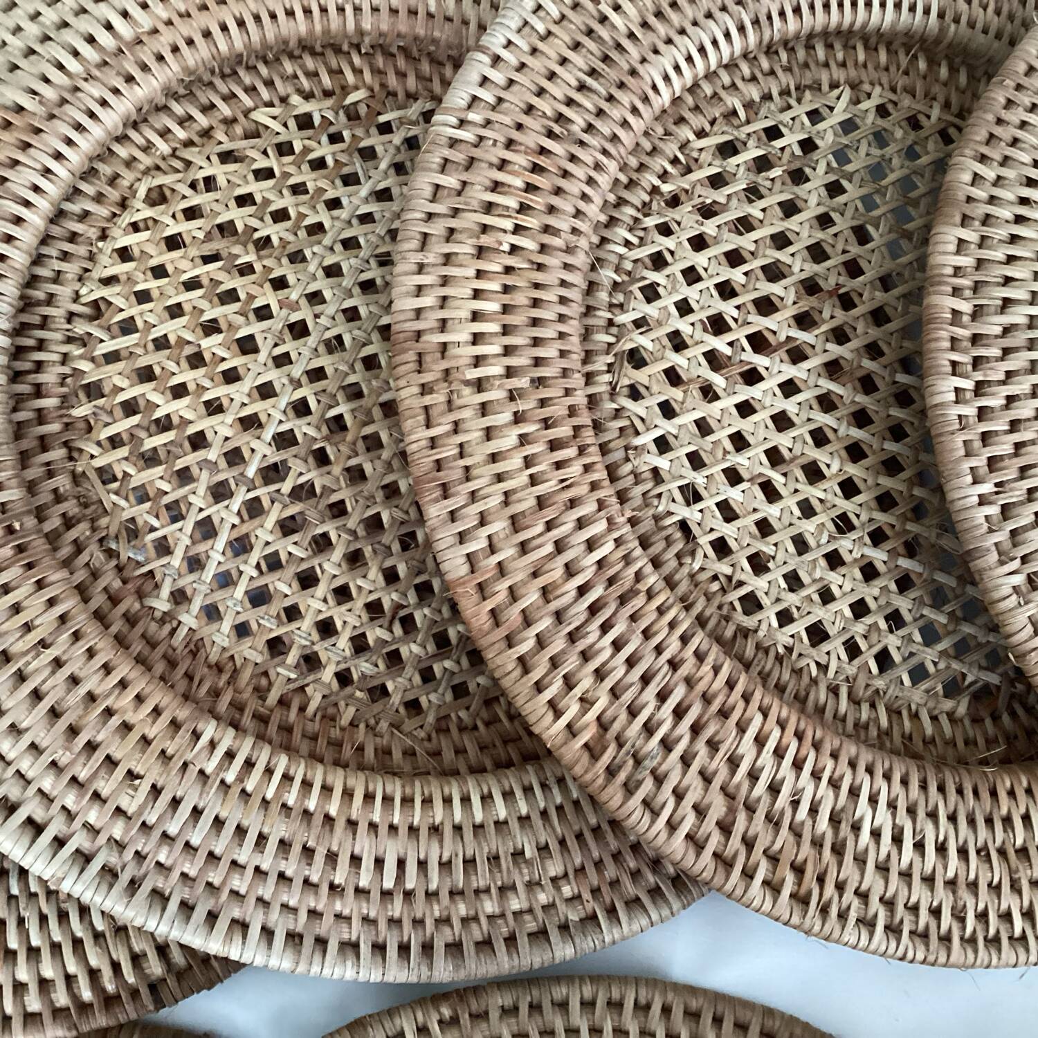 Set of round woven rattan and canework coasters