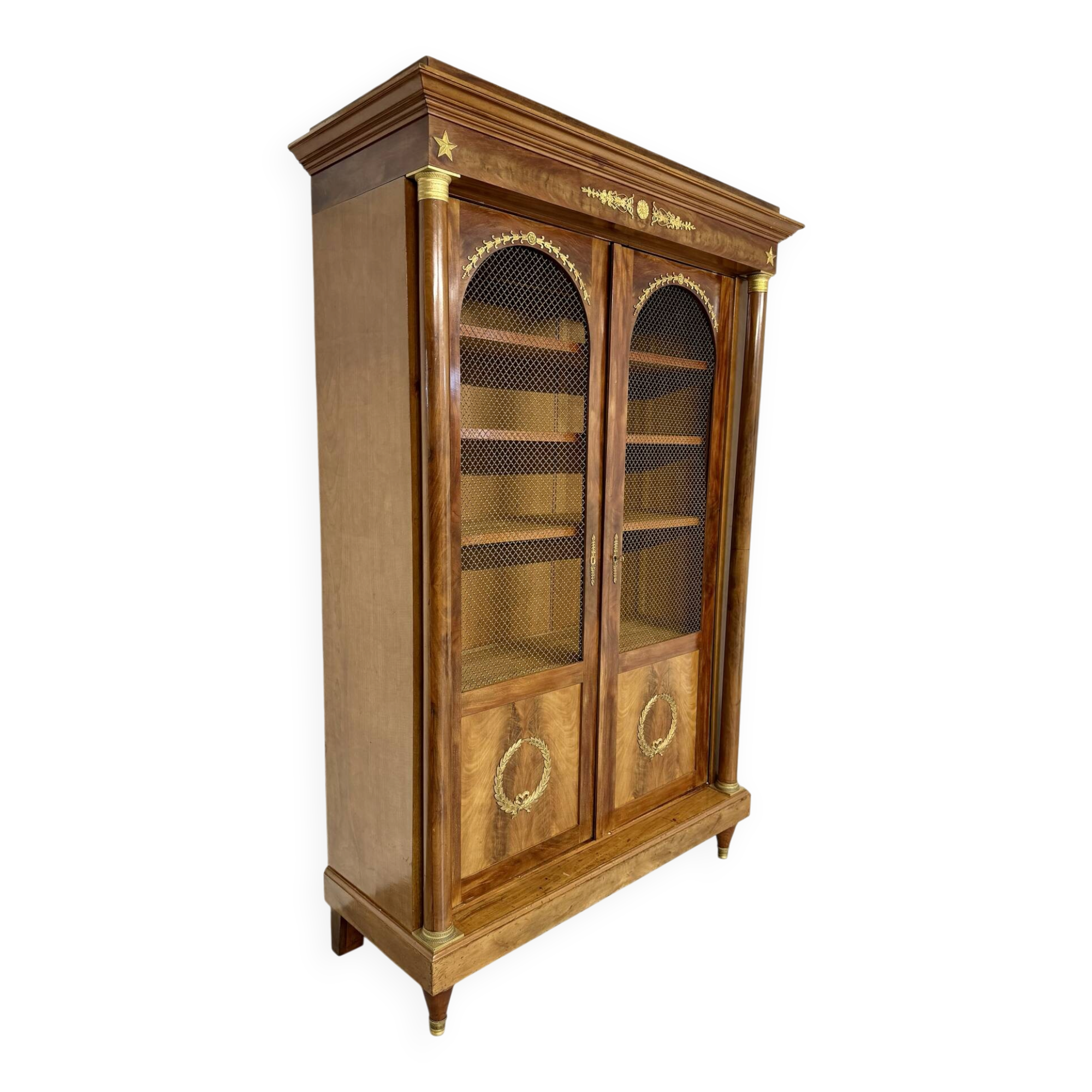Large Empire-style library in wood with gilded bronze ornaments.
