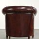 Vintage sheepskin club armchair with decorative nails and black piping