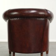 Vintage sheepskin club armchair with decorative nails and black piping