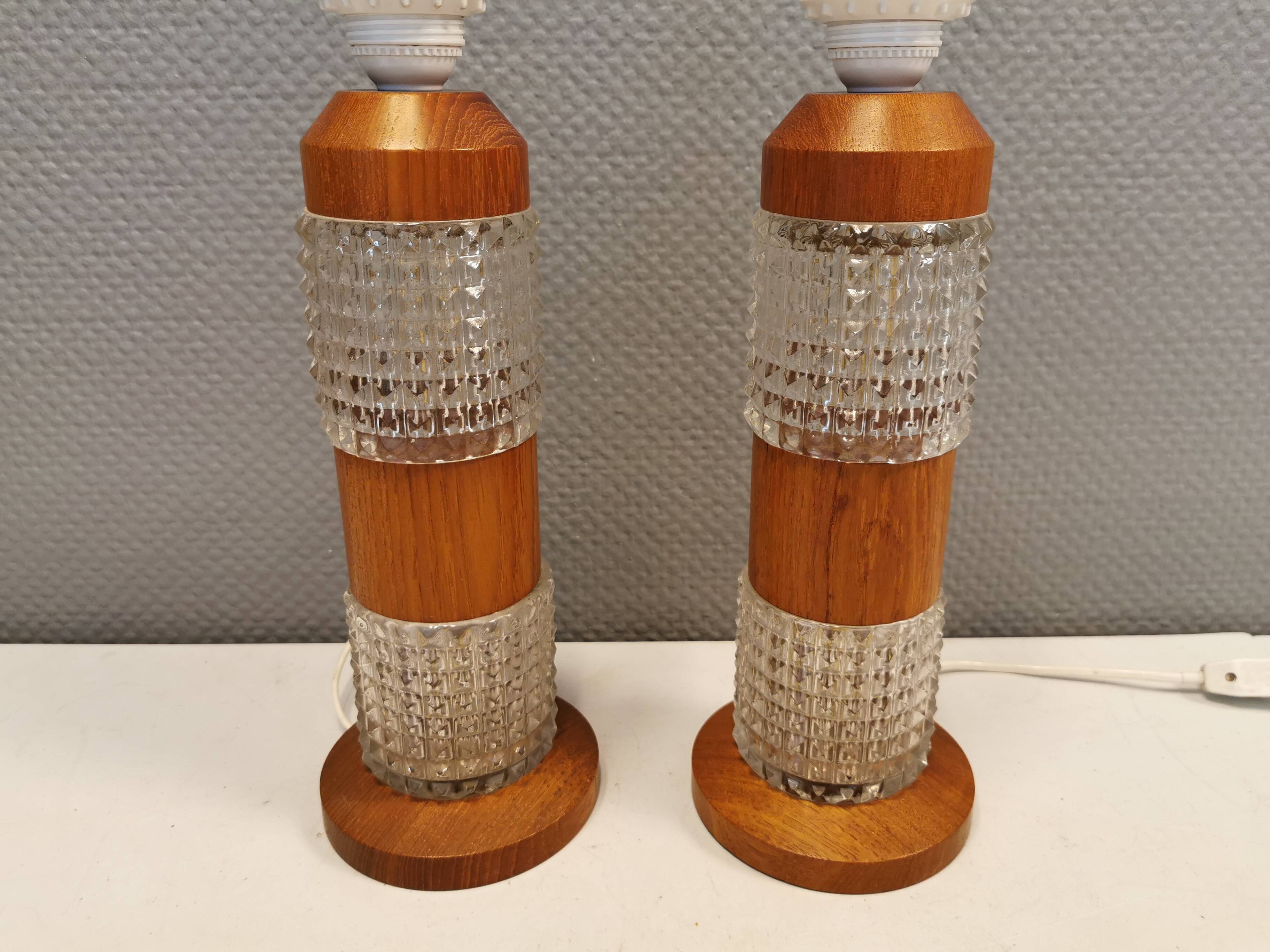 Swedish table lamps made of teak wood and hard pressed crystal glass.