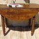 Antique walnut console table with honey spoon legs.