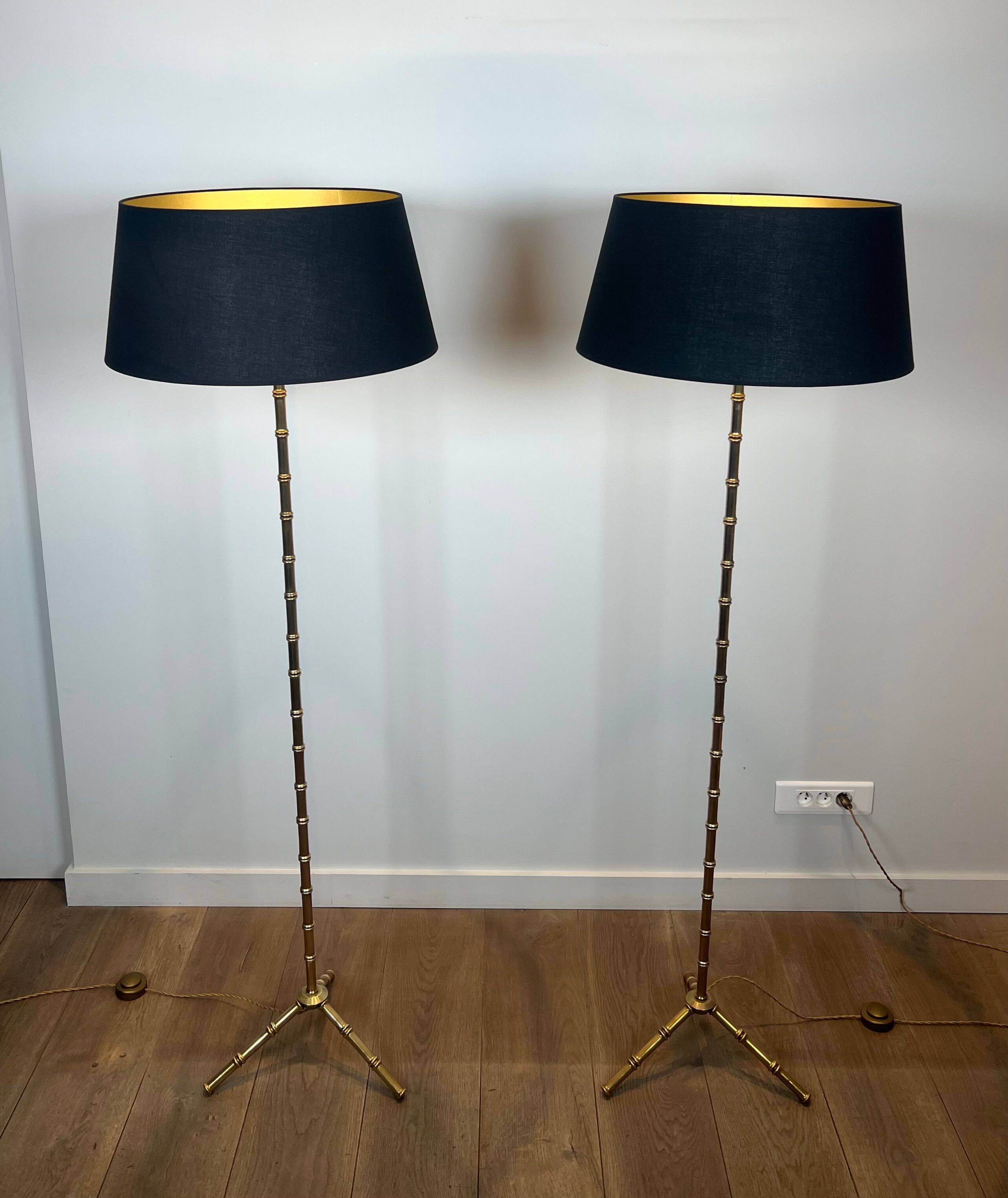 Pair of parquet floor lamps in faux-bamboo style in bronze and brass by Jacques Adnet.