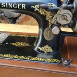 Old Singer sewing machine on its original base