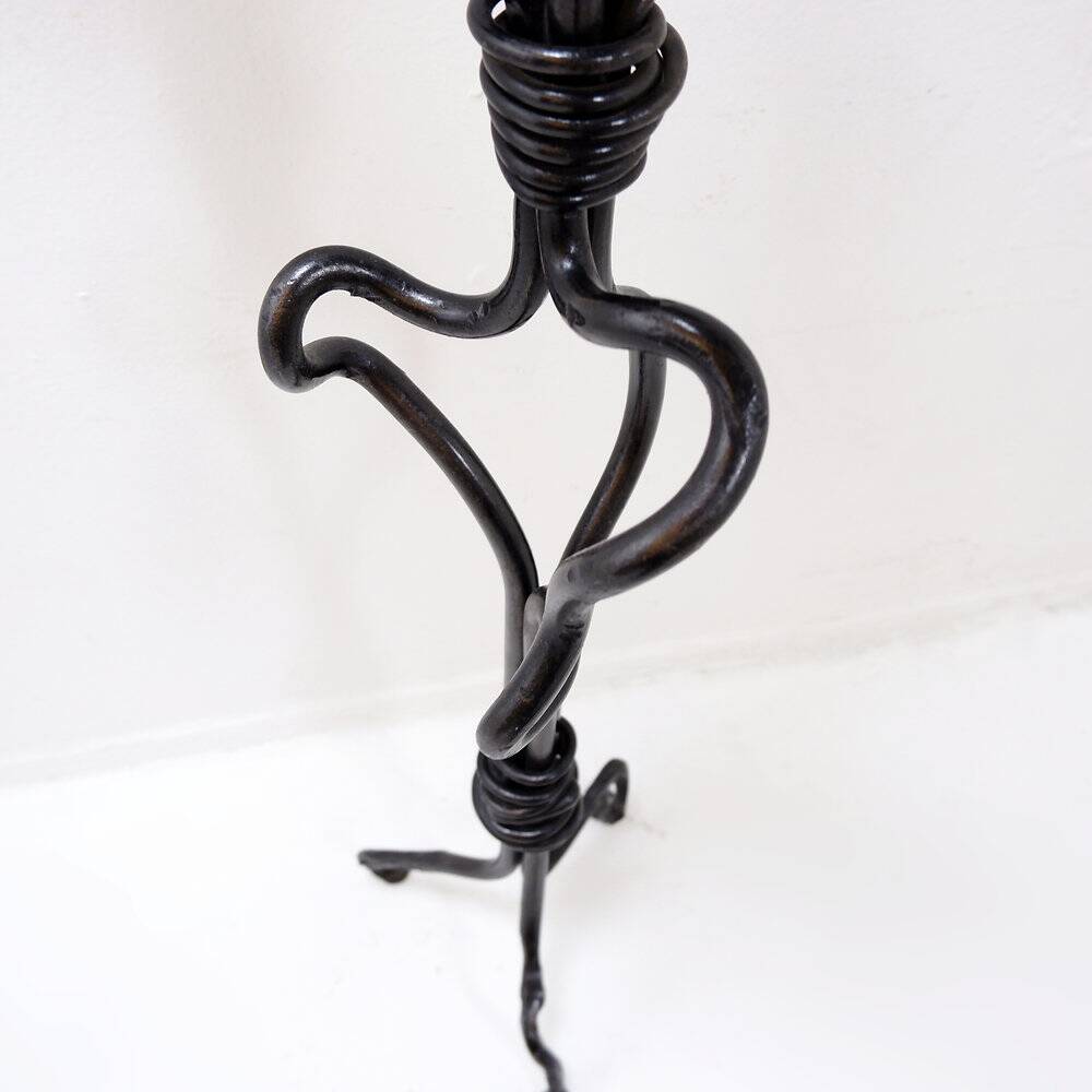 Large wrought iron candelabrum with an abstract design and three candle holders.