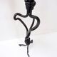 Large wrought iron candelabrum with an abstract design and three candle holders.