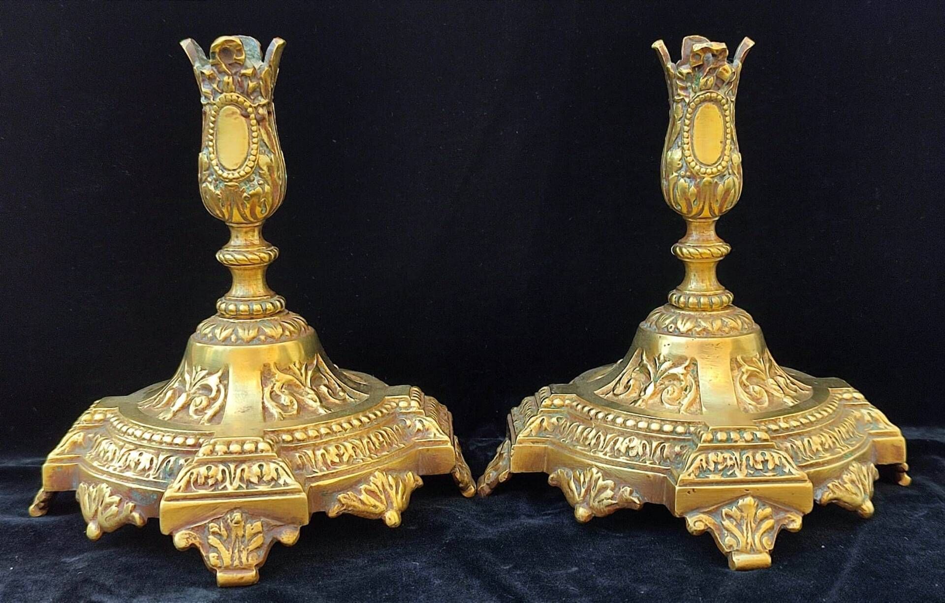 Pair of antique carved bronze candlesticks.