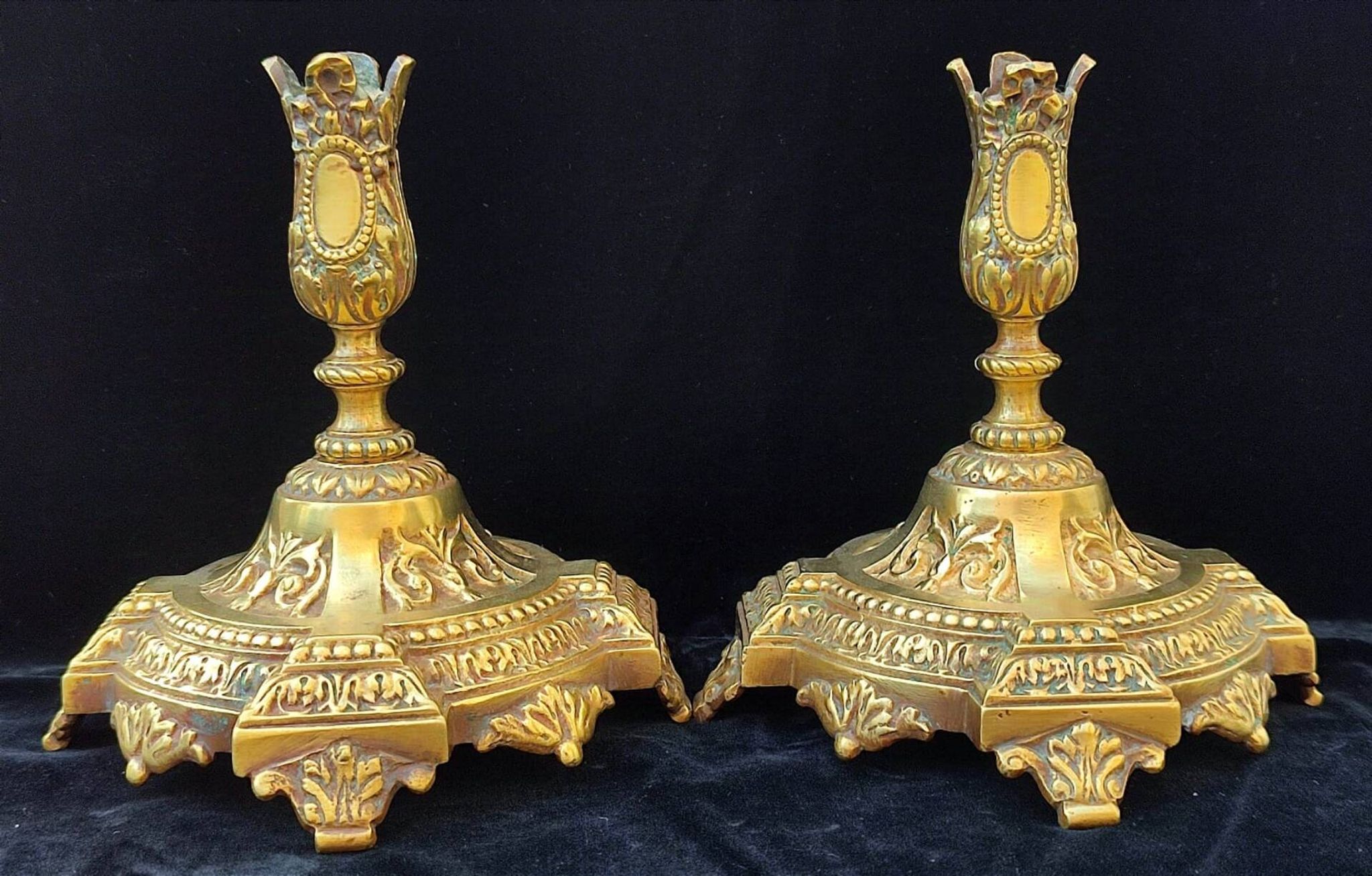 Pair of antique carved bronze candlesticks.