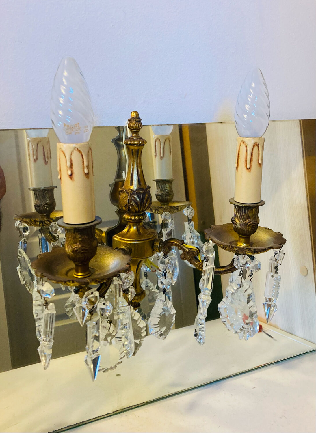 Pair of gilt bronze wall sconces with pendants from the mid-20th century.