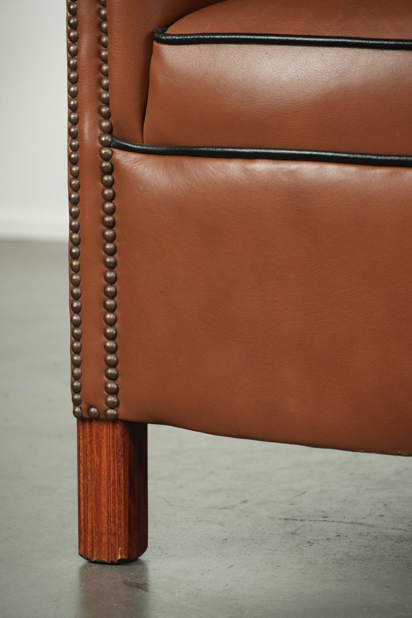 Cowhide club armchair in English style with comfortable seating.