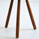 Old brutalist tripod stool in solid wood