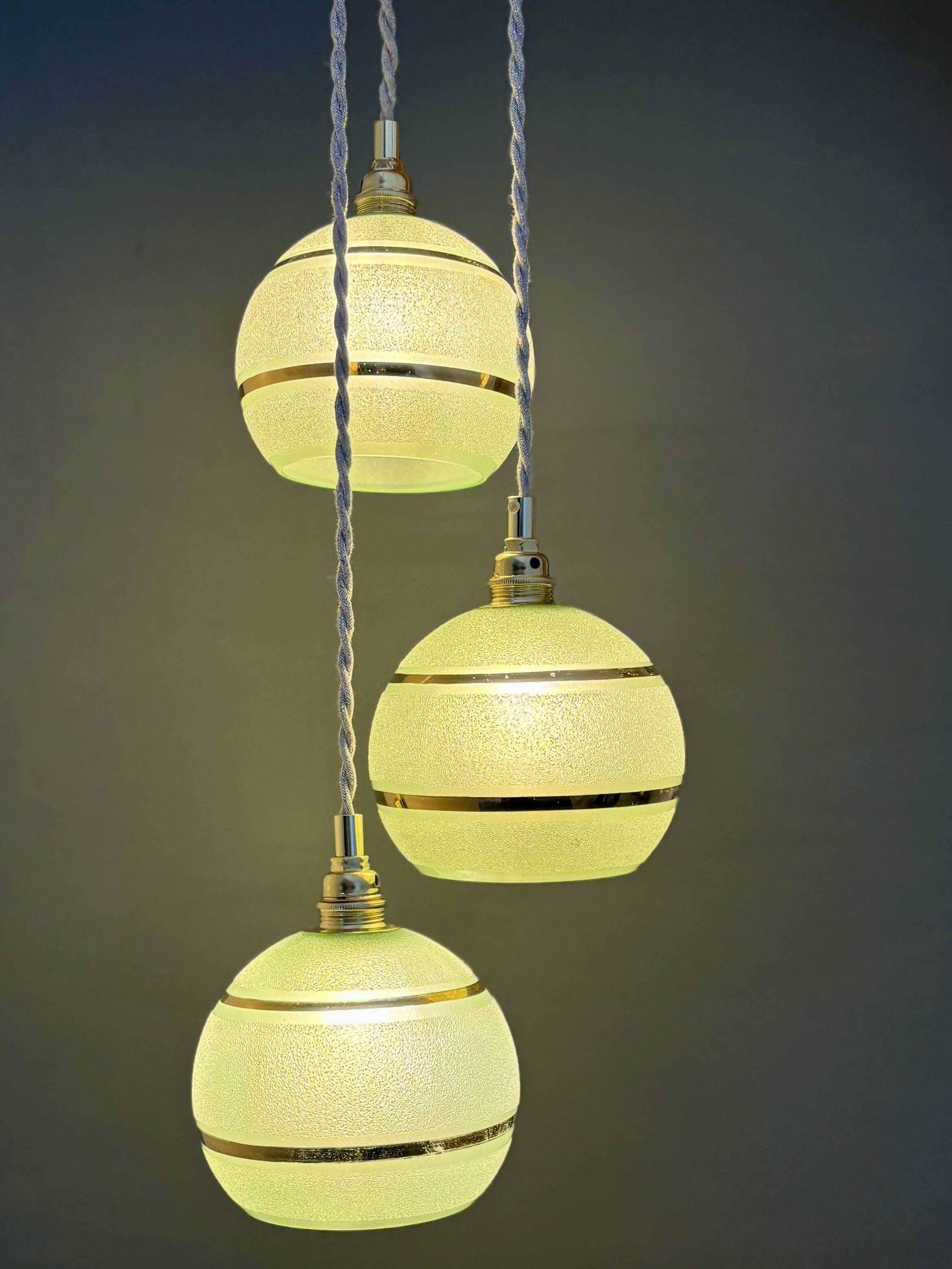 Suspension triple vintage glass globes in frosted green and gold.