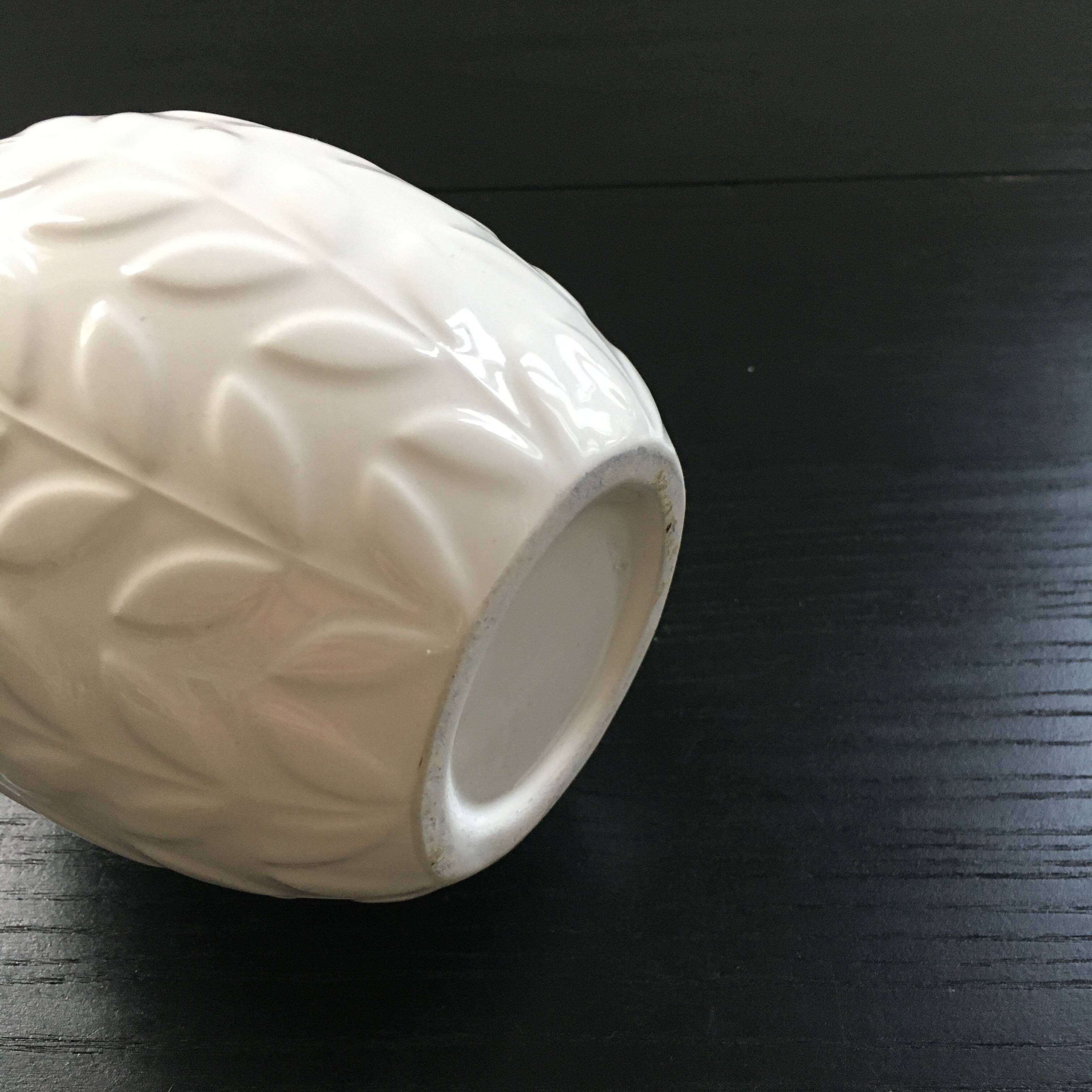 White vase with ear of corn decor