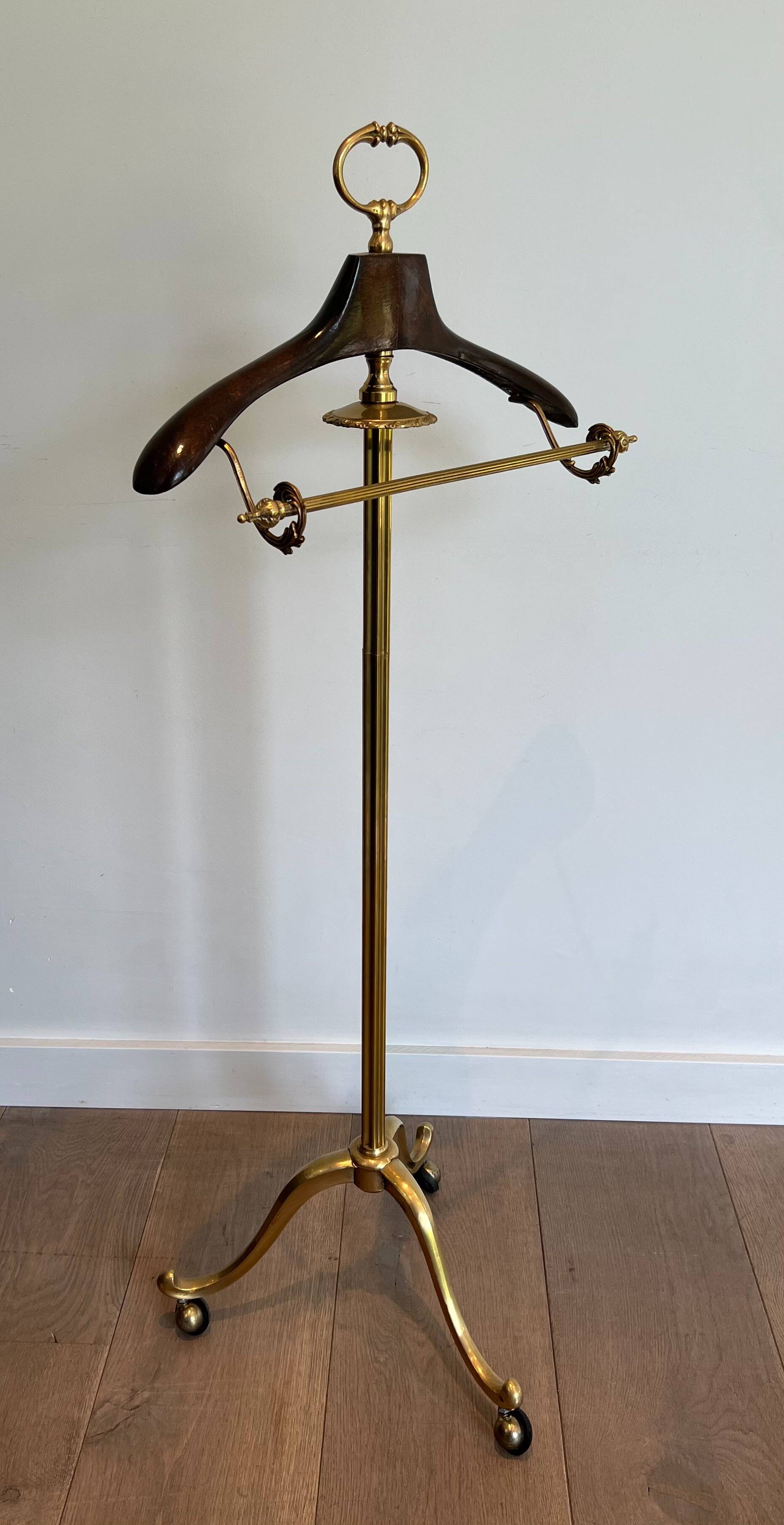 Neoclassical style valet stand in brass and black lacquered wood. French work. Circa 1940