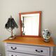 Beveled glass wall mirror in solid wood frame