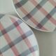 Two dessert plates Moulin des Loups with a pink and grey tablecloth design.