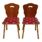 2 curved wood and red fabric chairs