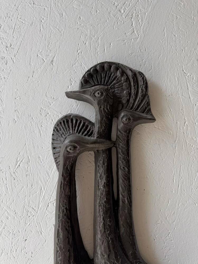 Brutalist wall sculpture with birds Ars Munda