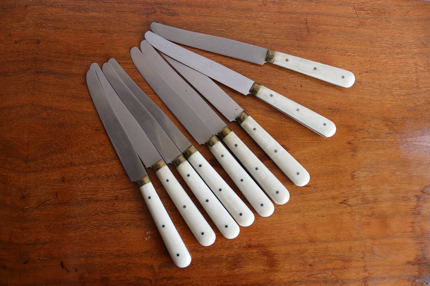 Set of 9 vintage cream table knives