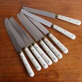 Set of 9 vintage cream table knives