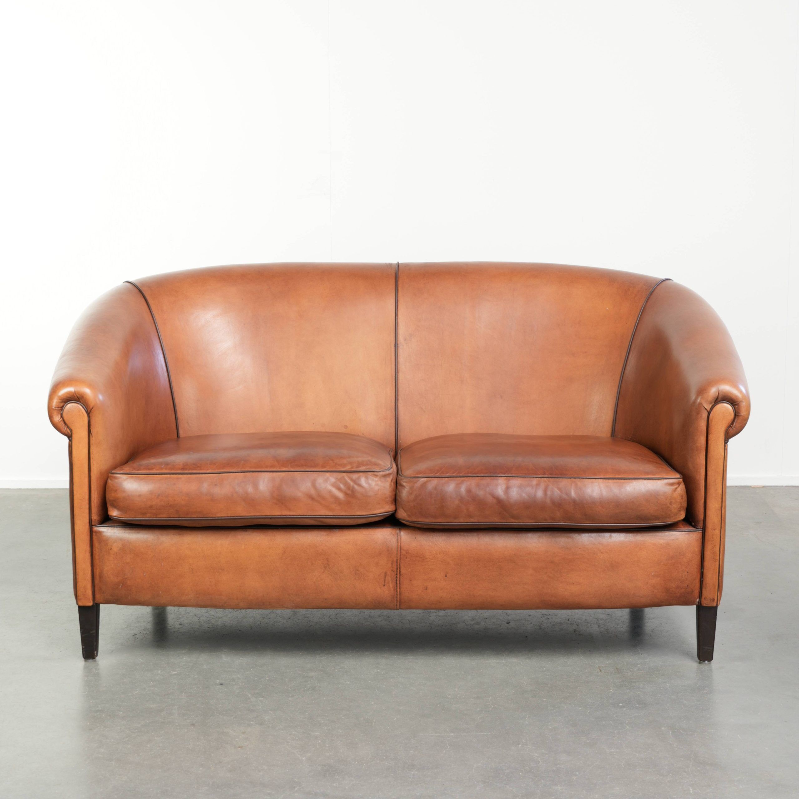 Sheepskin 2-seater sofa with a warm cognac brown colour scheme