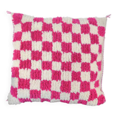 Berber cushion with a pink checkerboard pattern.