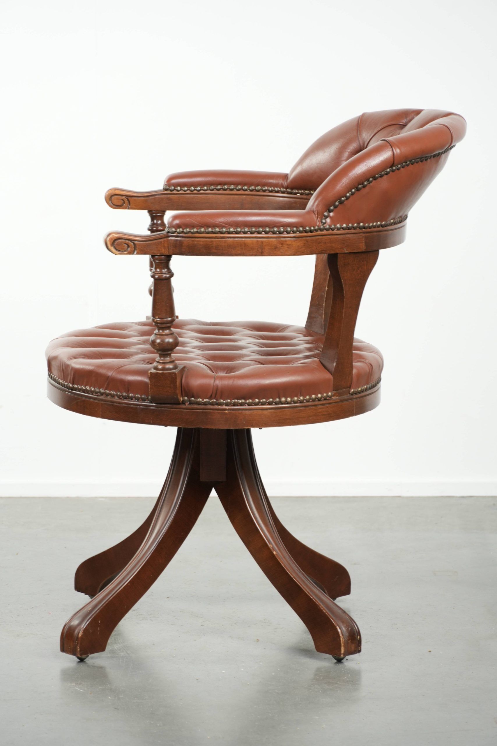 Swivel cowhide English style chesterfield office chair in a brown colour