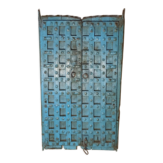 Old blue wooden door with braces