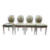 Suite de 4 chaises médaillons de style Louis XVI rechampi blanc cassé