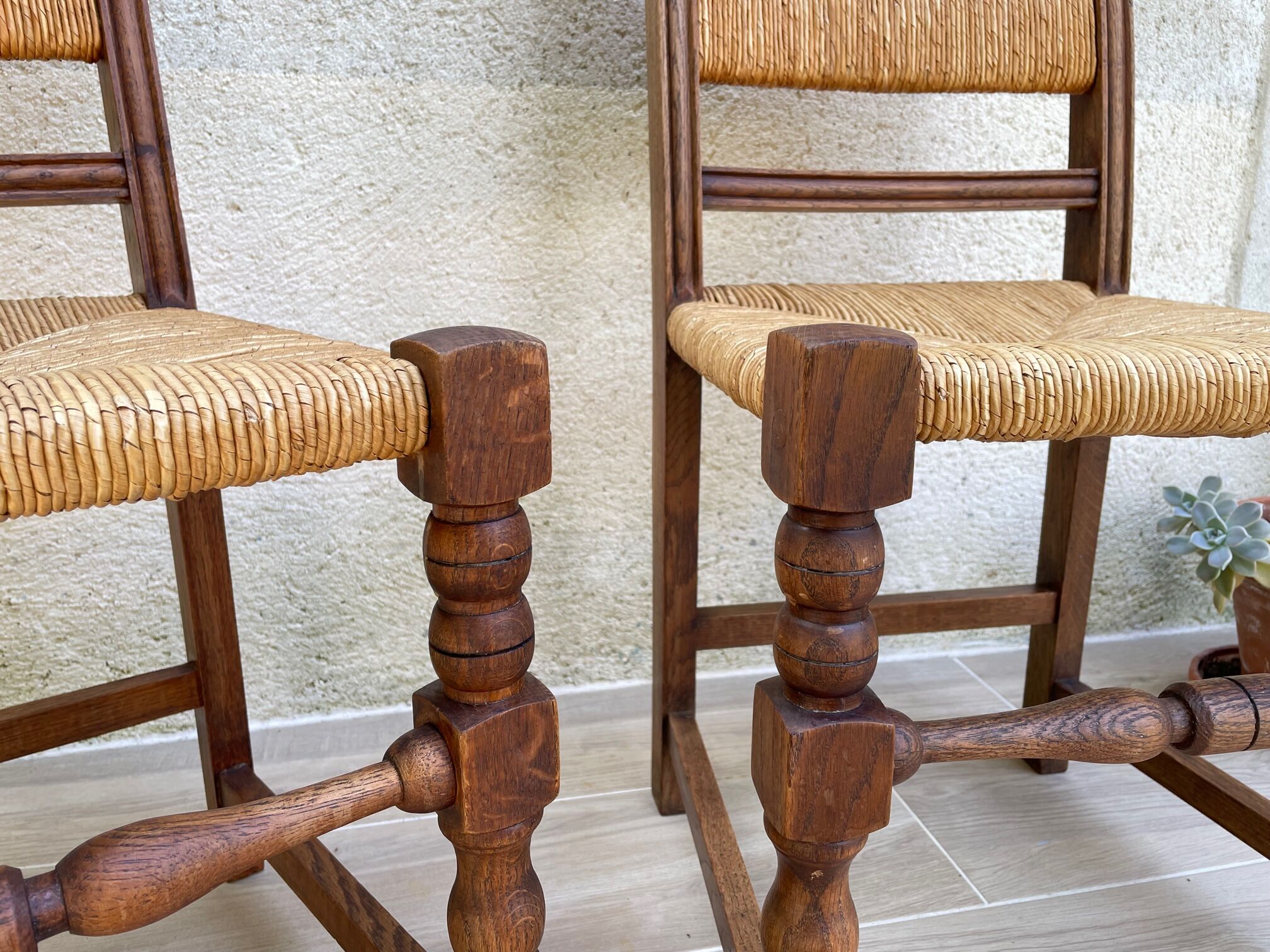 Pair of straw and solid oak chairs