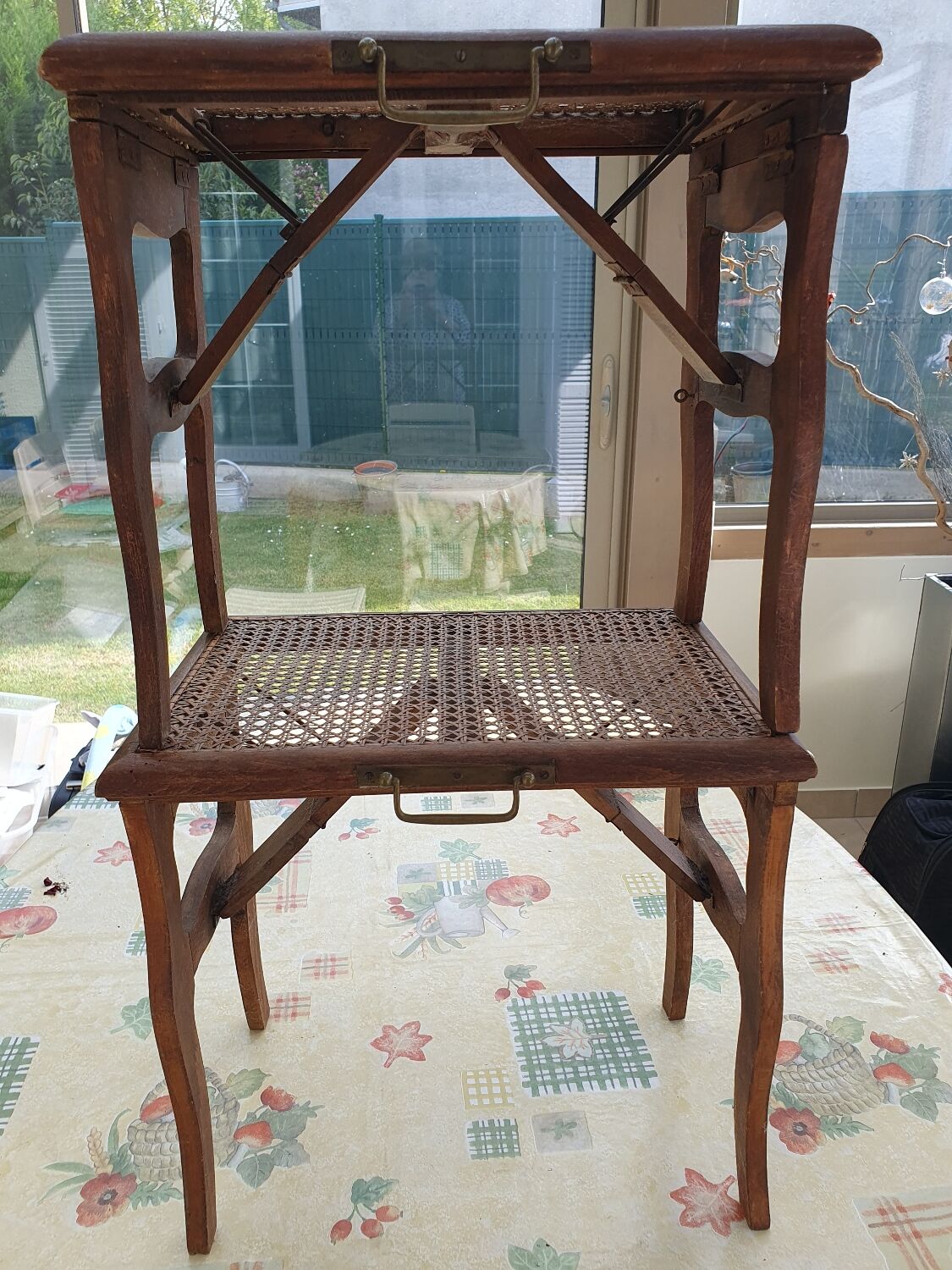 Two folding stools with caned seats.