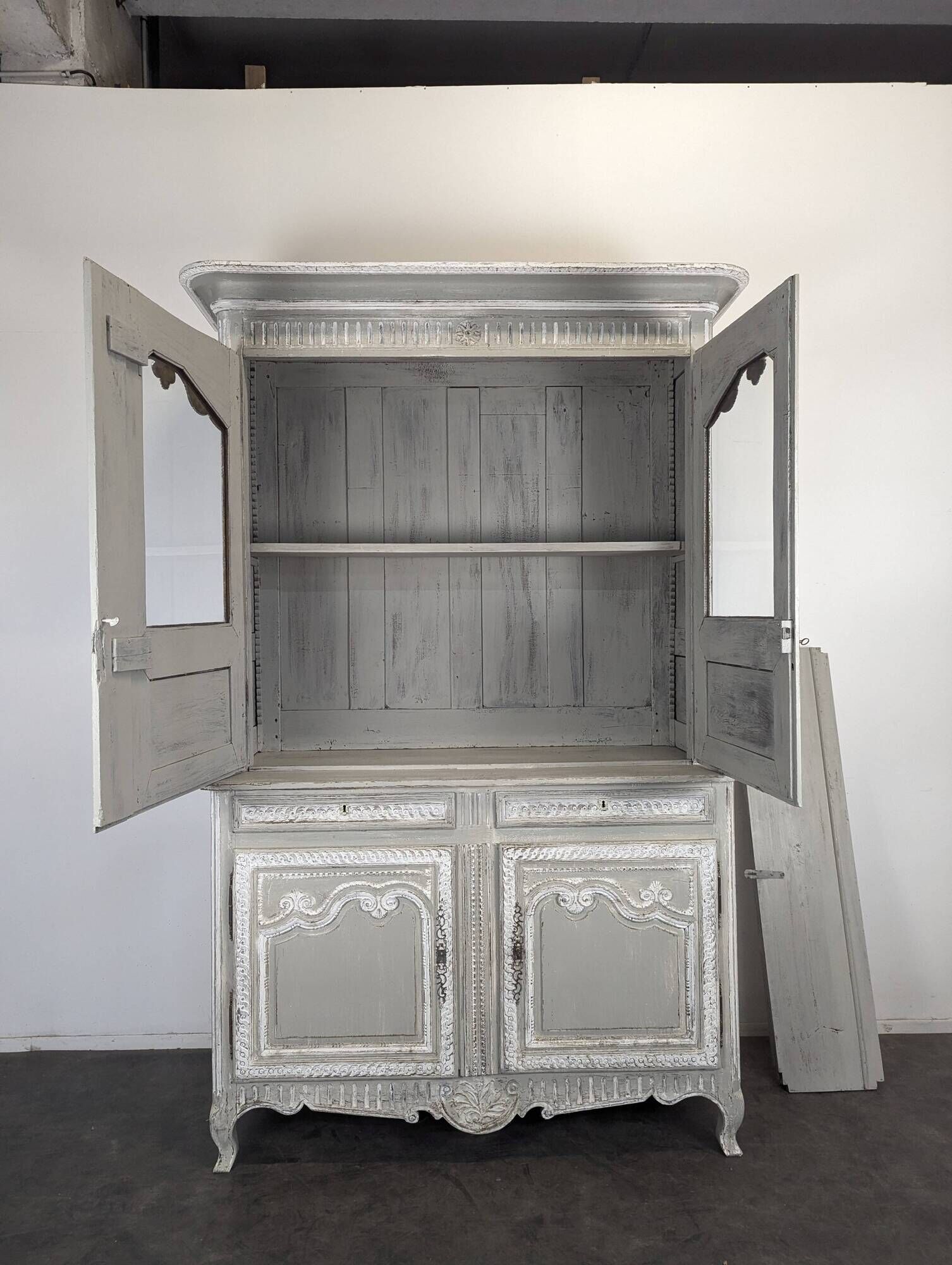 Two-body glass buffet in patinated grey and white oak.