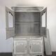 Two-body glass buffet in patinated grey and white oak.