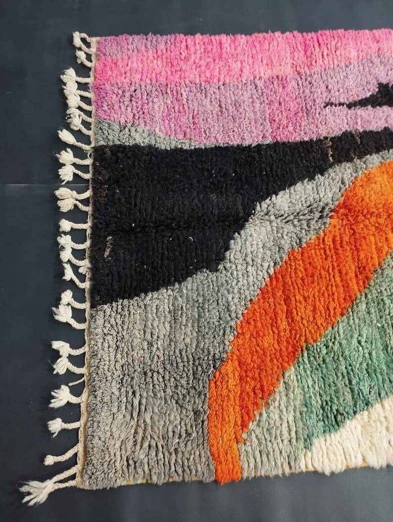 Large handmade Moroccan rug with colourful patterns.