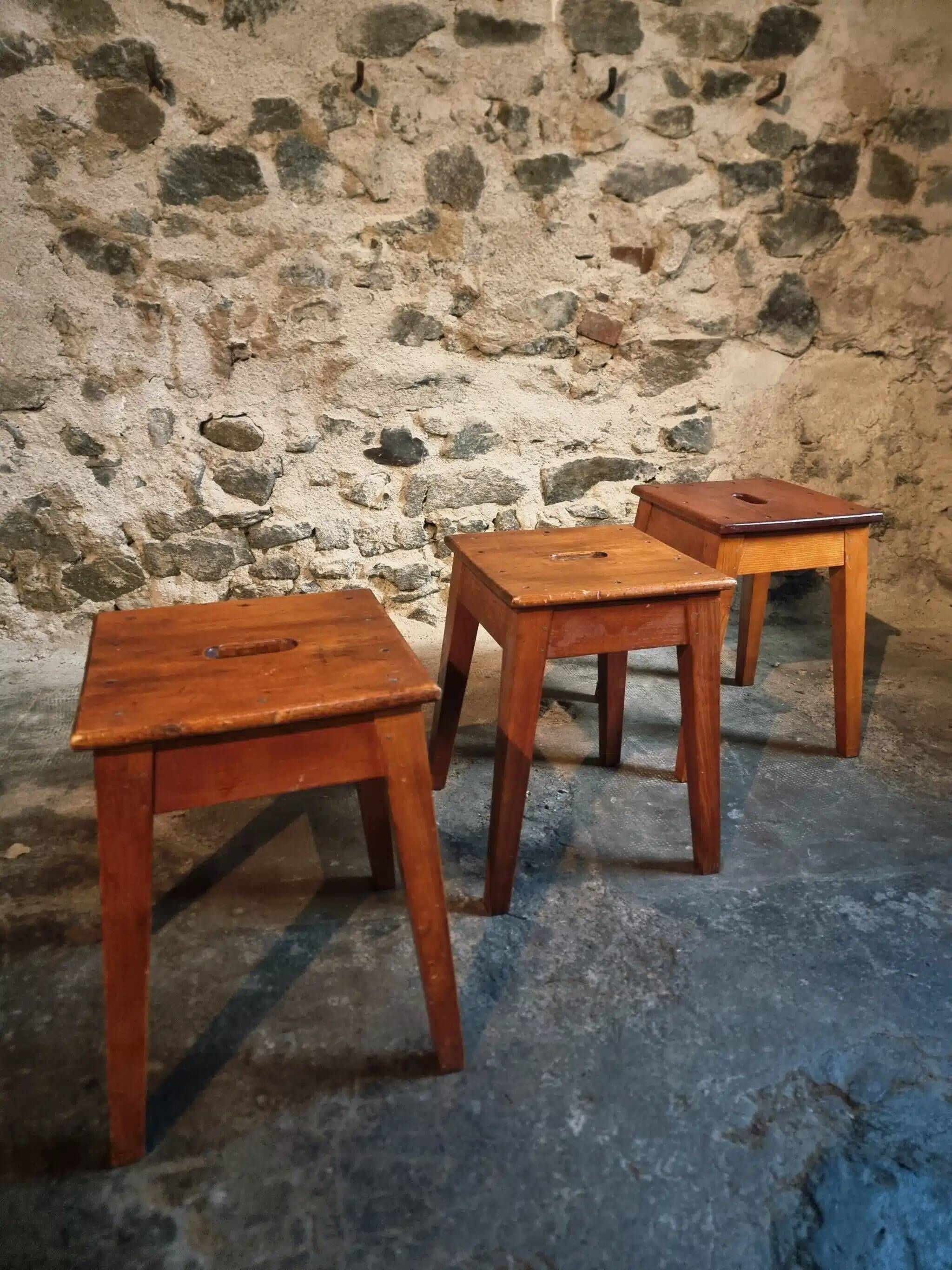 Set of 3 vintage French wooden stools from the 1950s.