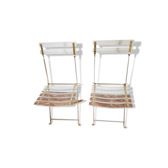 Folding chairs with gold metal structure and methacrylate slats seat and back.