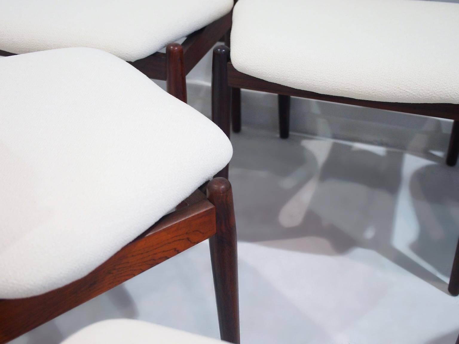 Set of six hardwood chairs by Arne Vodder for Sibast with white textile upholstery.