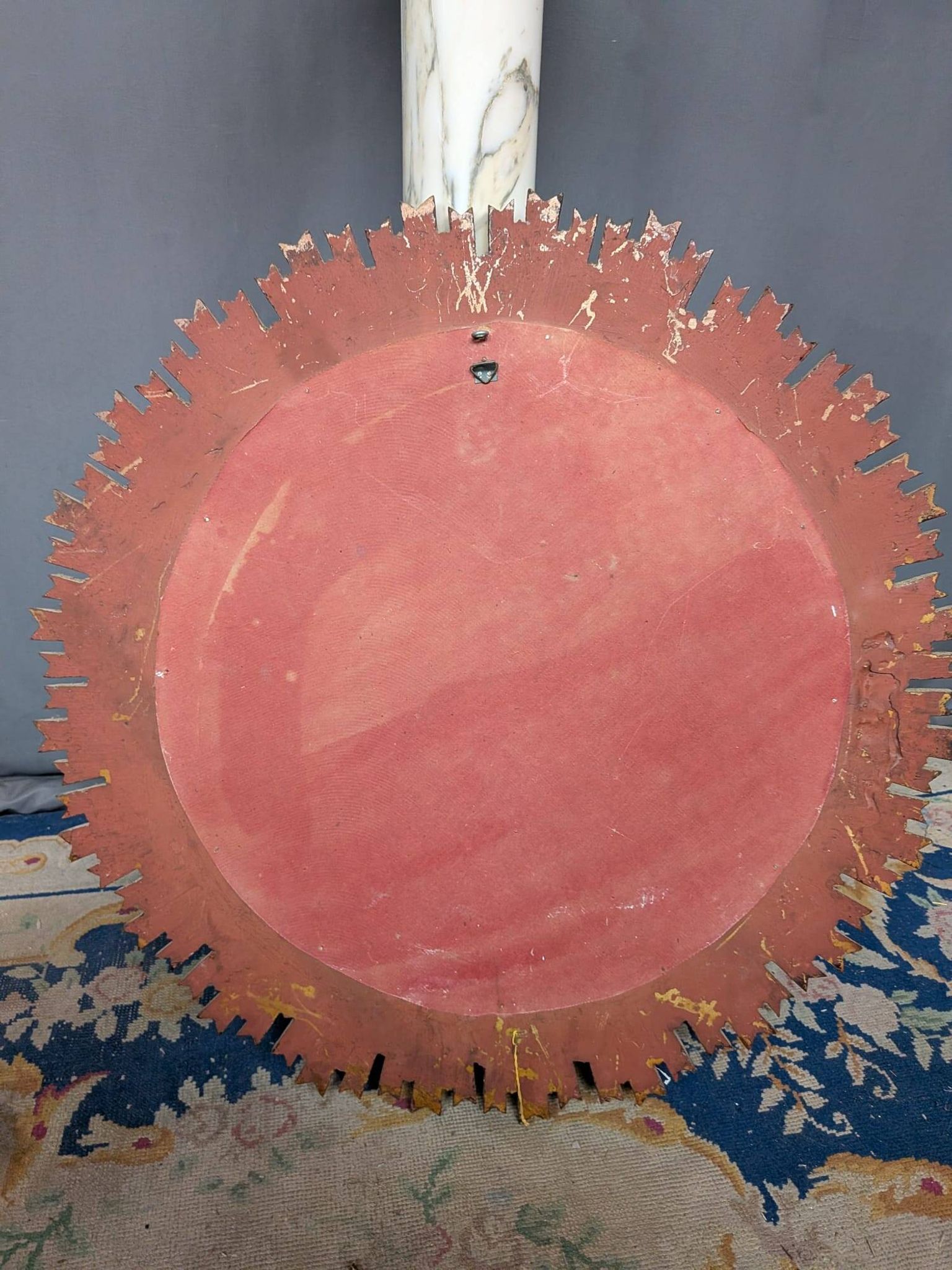 Large wooden mirror with golden sun rays, in Art Deco style.