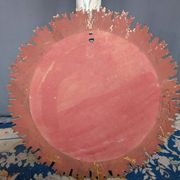 Large wooden mirror with golden sun rays, in Art Deco style.