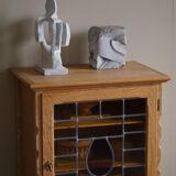 Scandinavian wardrobe in natural oak with a glass front.