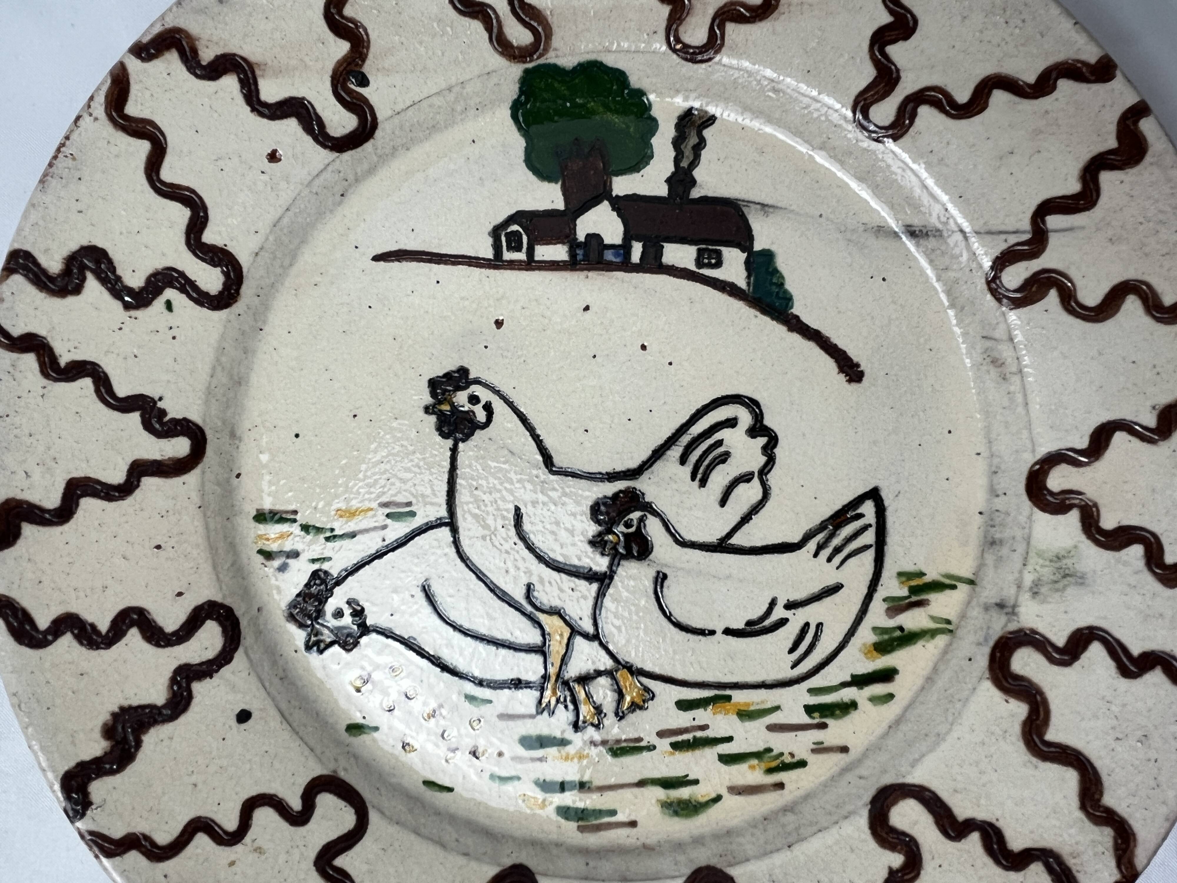 Old terracotta plate decorated with chickens, Portugal, 20th century.