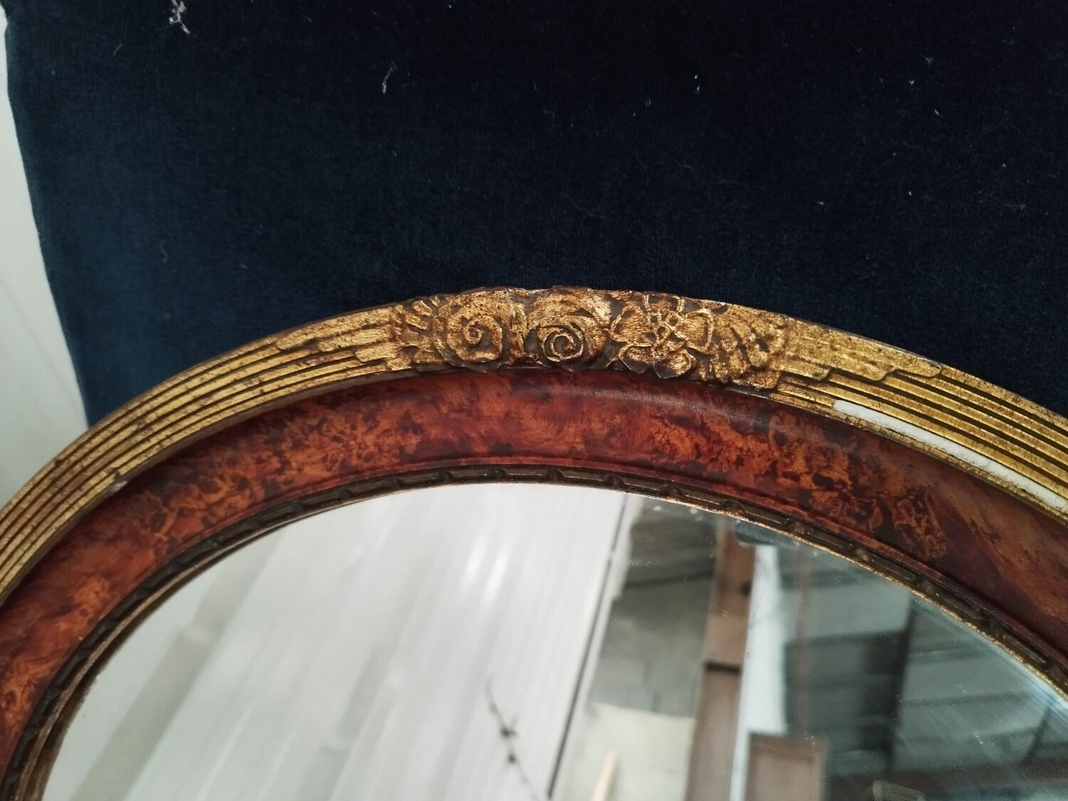 Golden oval art deco mirror