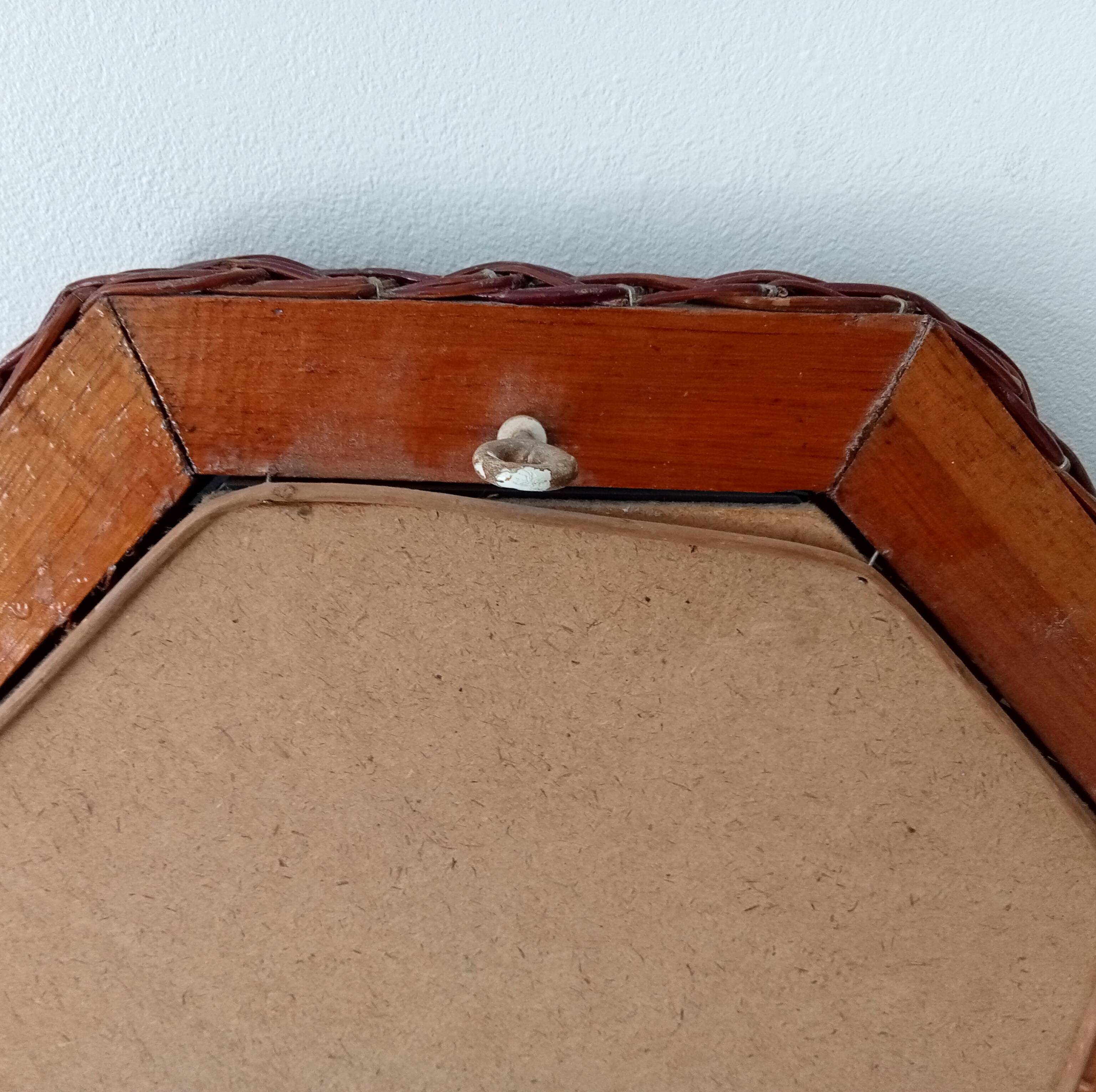 Vintage octagonal mirror in woven rattan.