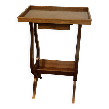 Nightstand in the shape of a lyre.